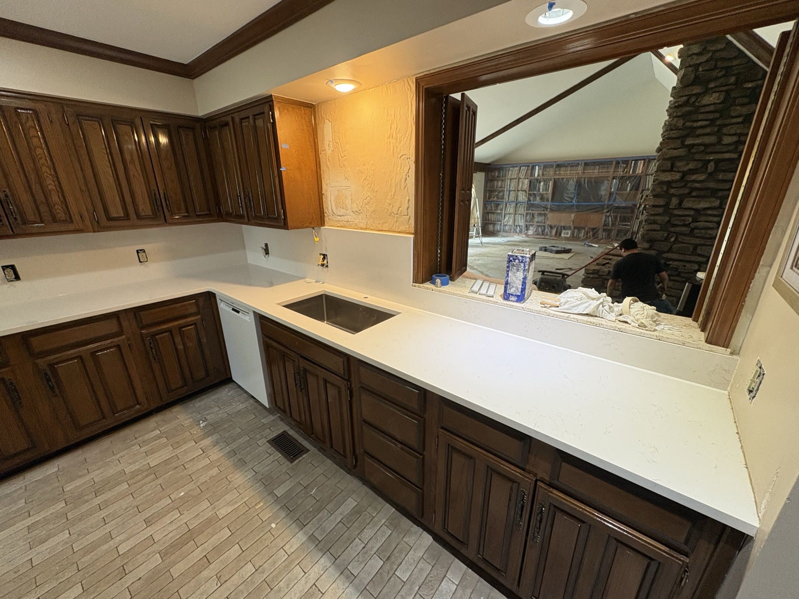 Traditional kitchen with white quartz countertops and dark wood cabinets